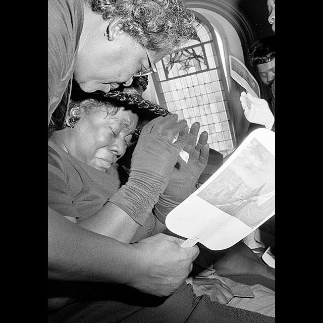 A black and white photograph of Exerlena Jackson during the memorial service for her husband, Wharlest Jackson