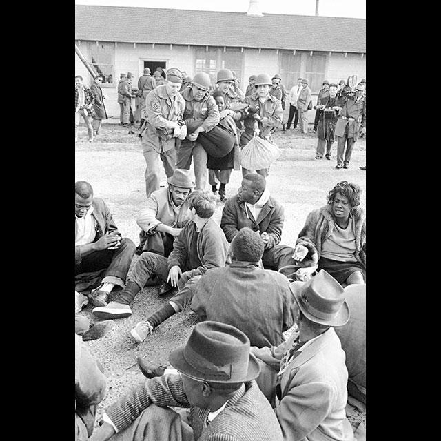 A black and white photograph of squatters at Greenville Air Force Base