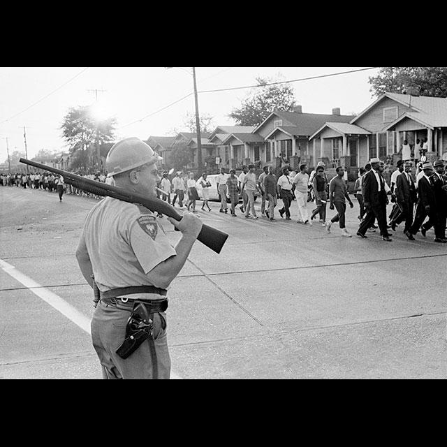 A black and white photograph of a march after the Jackson State shooting